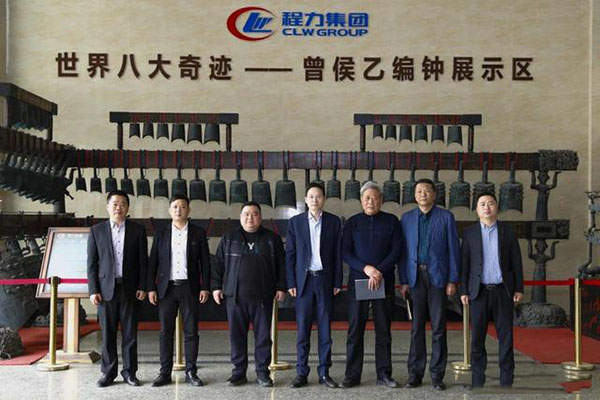 在程力汽車集團總部迎賓大廳，雙方代表觀摩世界八大奇跡編鐘后合影紀(jì)念